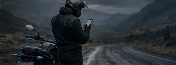 Motorcyclist checking route conditions before riding on a wet mountain road.